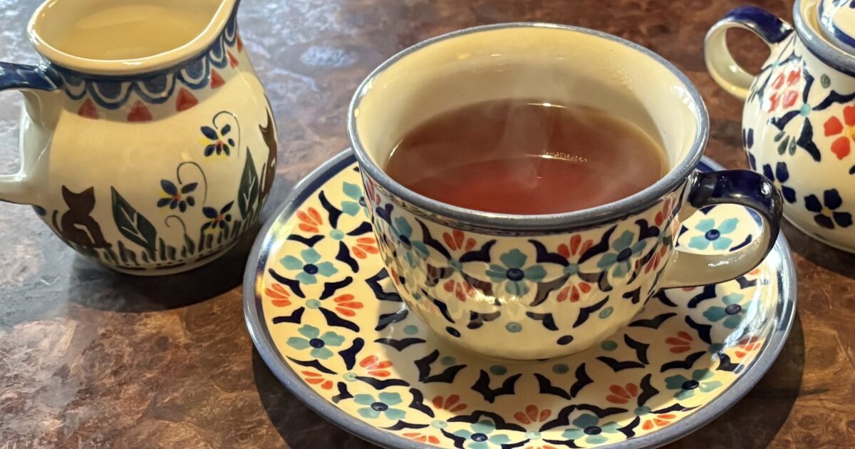 北欧風カップに入った紅茶とミルクポット